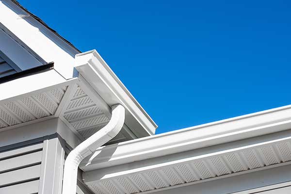 White, k-style gutter systems attached to the fascia of a home