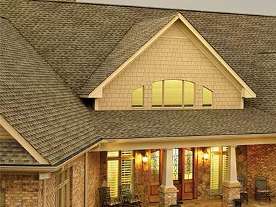 Residential home with brown GAF shingles on its roof